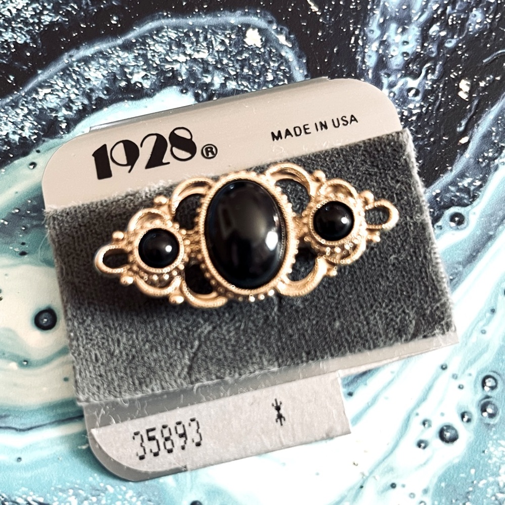 New 1928 silver tone & black brooch